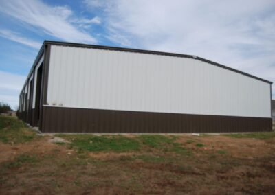 Large Metal Equipment Storage Building Tan/Brown Side View