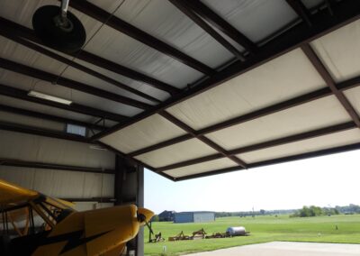 Metal Airplane Hangar Interior With Door Open